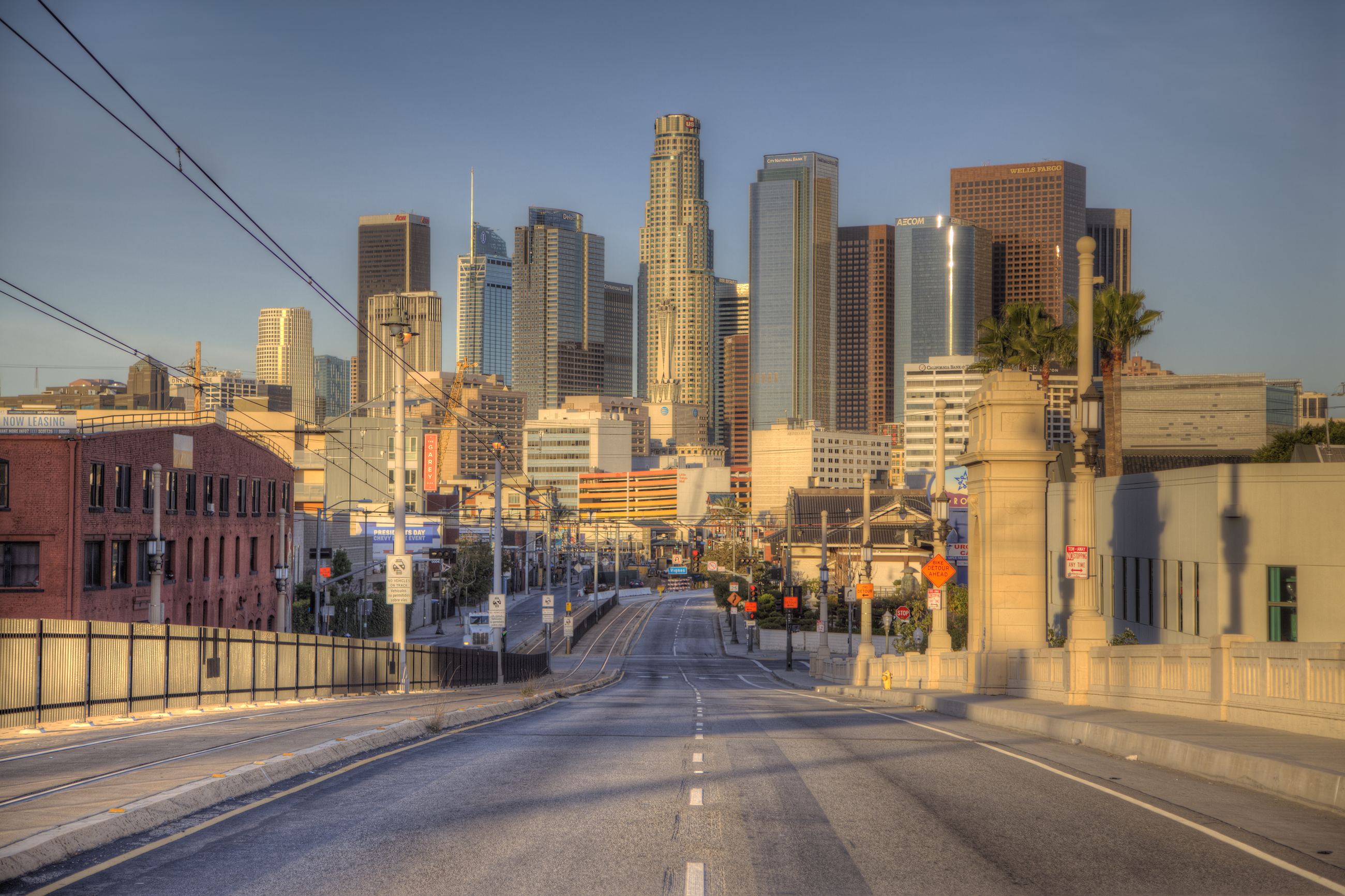 An empty viaduct in early light, leading straight into the towers of Downtown Los Angeles